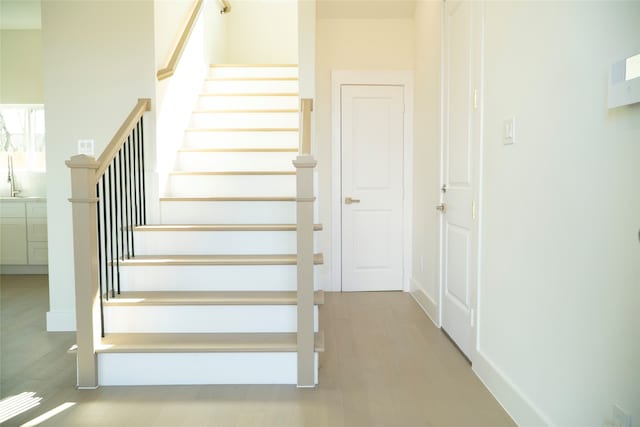 stairway featuring wood-type flooring