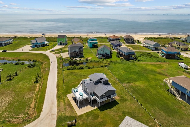 bird's eye view with a water view and a beach view