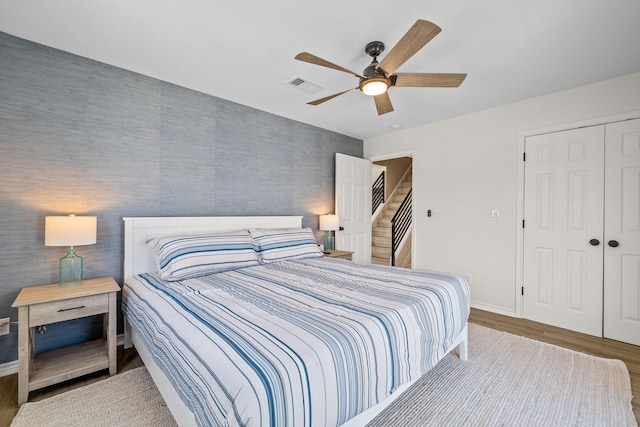 bedroom with ceiling fan, a closet, and hardwood / wood-style floors