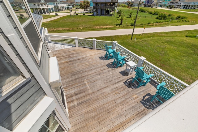 wooden deck featuring a lawn