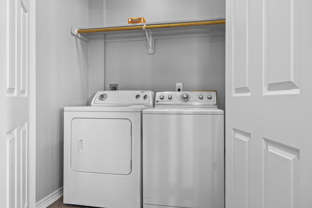 clothes washing area with washing machine and clothes dryer