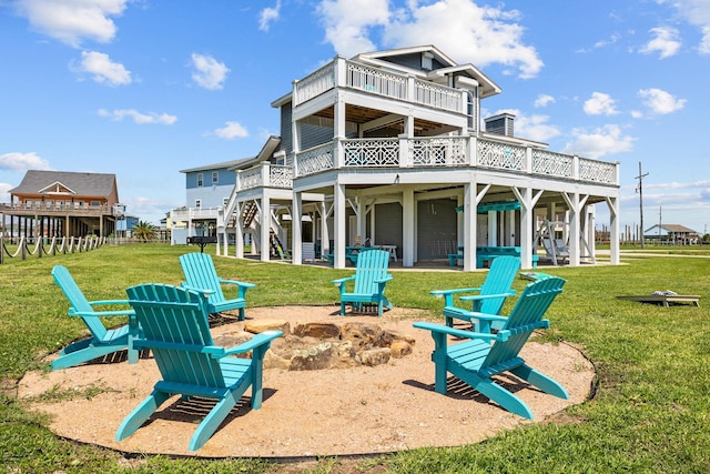 back of property with a patio, a deck, an outdoor fire pit, and a lawn