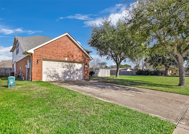 view of side of home featuring a garage, a yard, and central AC