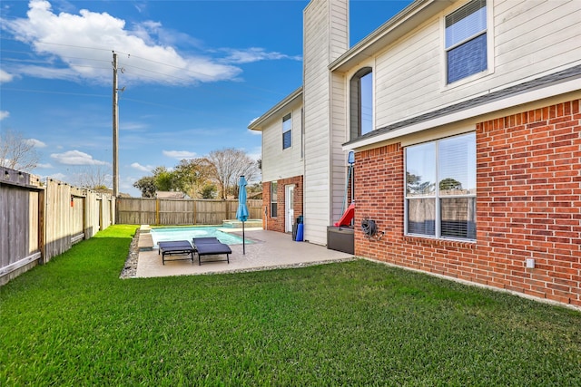 back of house featuring a patio area, a yard, and a covered pool