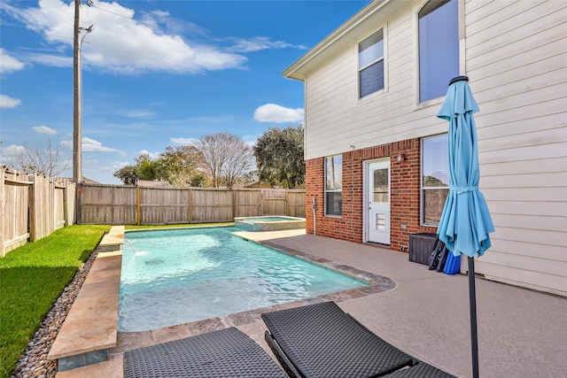 view of swimming pool with an in ground hot tub, pool water feature, and a patio