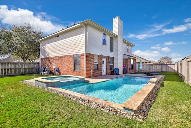 back of property featuring a lawn and a pool with hot tub