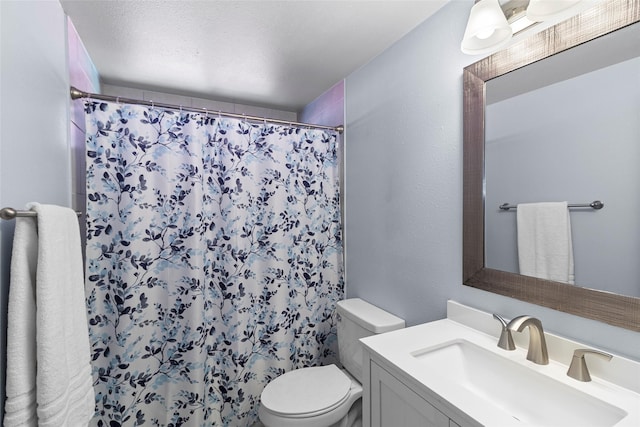 bathroom with a shower with curtain, vanity, a textured ceiling, and toilet