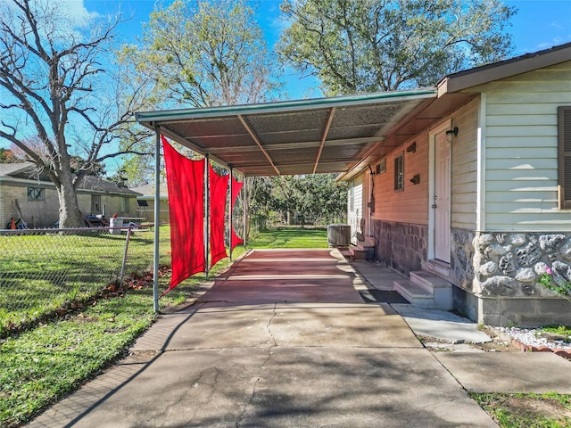 view of vehicle parking featuring a carport and a lawn