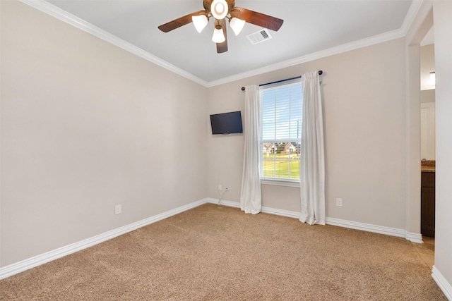 unfurnished room with ornamental molding, carpet, and ceiling fan