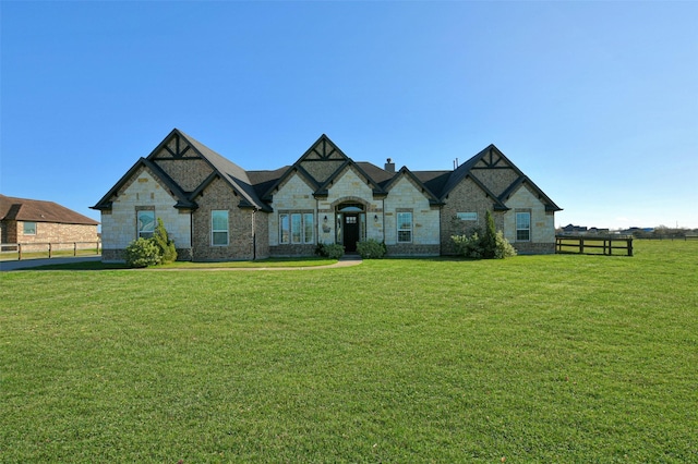 french country style house with a front yard