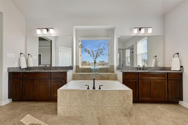 bathroom with vanity, plus walk in shower, and tile patterned flooring