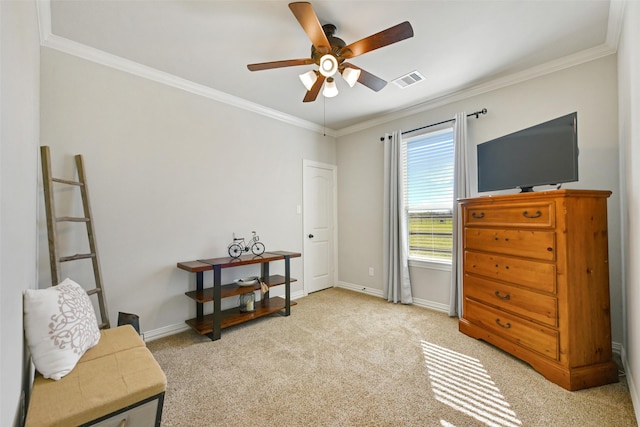 sitting room with ceiling fan, ornamental molding, and light carpet