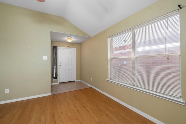 foyer with light hardwood / wood-style floors and lofted ceiling