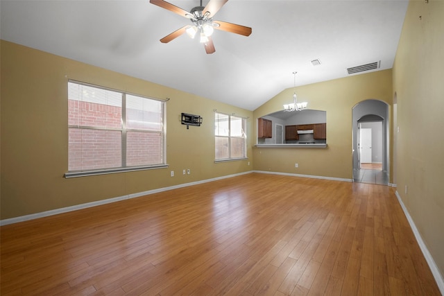 unfurnished living room with ceiling fan with notable chandelier, light hardwood / wood-style floors, and lofted ceiling