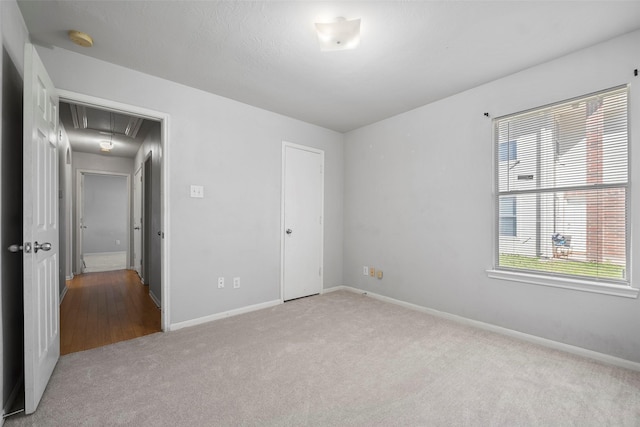 unfurnished bedroom with light carpet