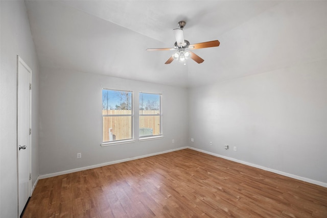 spare room with hardwood / wood-style flooring and ceiling fan