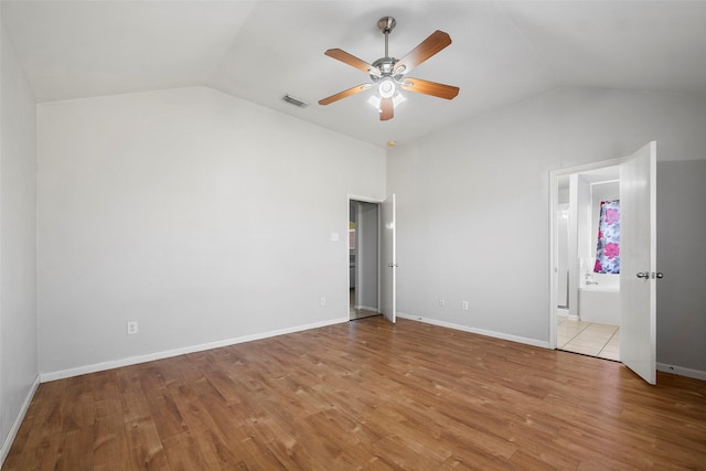 unfurnished bedroom with light wood-type flooring, vaulted ceiling, and ceiling fan