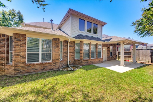 rear view of house featuring a patio area and a lawn