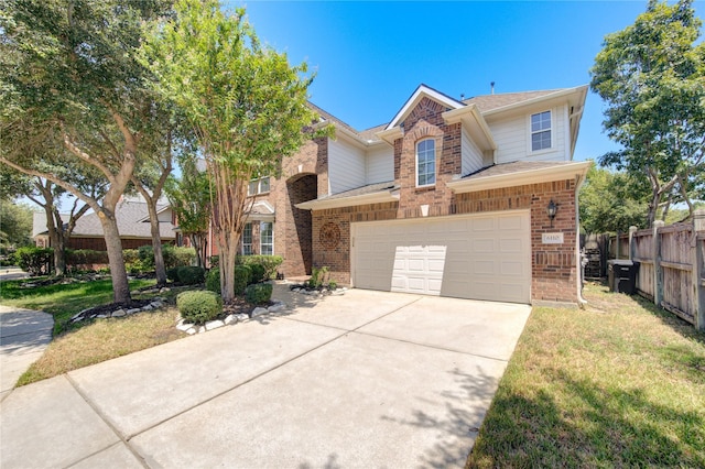 view of front property featuring a garage and a front lawn