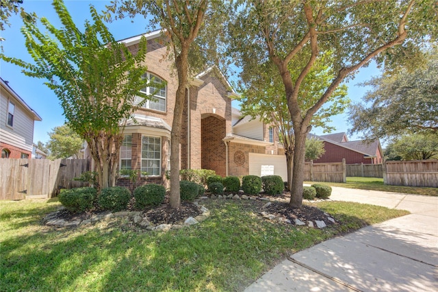 view of front of property featuring a garage and a front yard