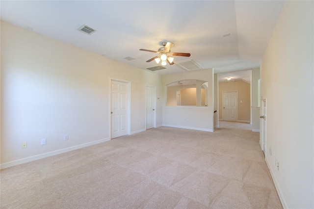 spare room featuring light colored carpet and ceiling fan