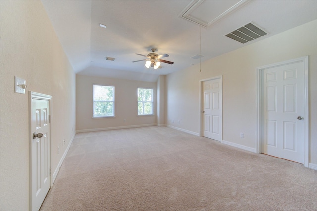 carpeted empty room featuring ceiling fan and vaulted ceiling