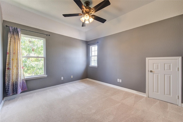 empty room with ceiling fan and light carpet