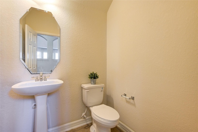 bathroom with toilet and sink