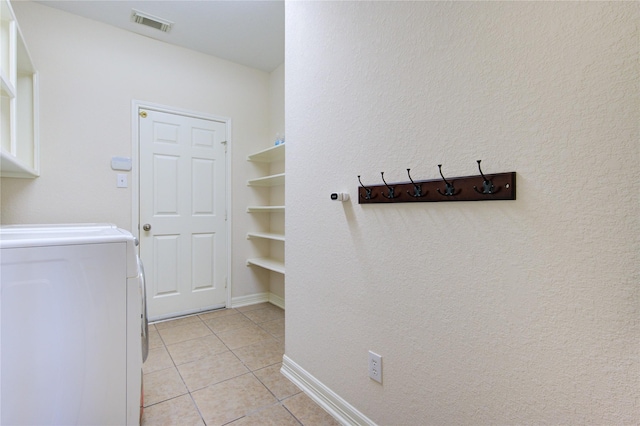 laundry area featuring light tile patterned flooring and washer / clothes dryer