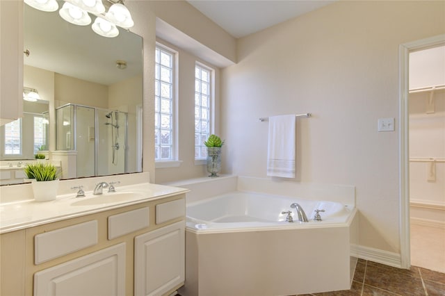 bathroom with plus walk in shower, tile patterned flooring, and vanity