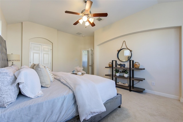 bedroom with ceiling fan, light colored carpet, and vaulted ceiling