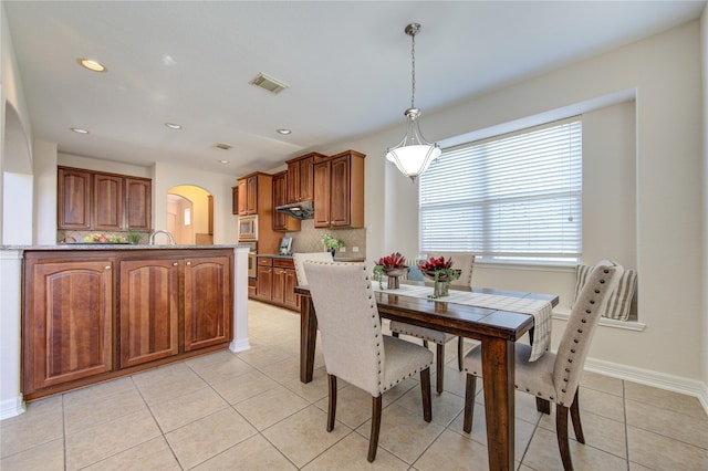 tiled dining area featuring sink