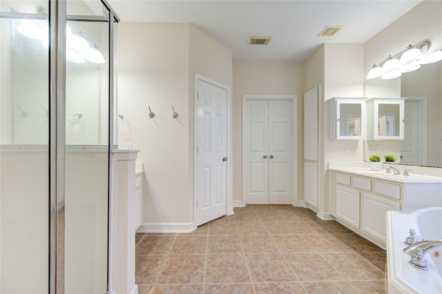 bathroom with vanity and independent shower and bath