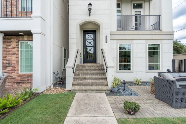 entrance to property with a balcony and a patio area