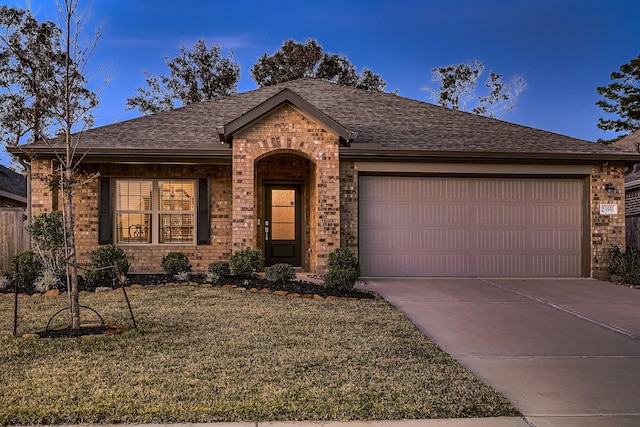 single story home with a front yard and a garage