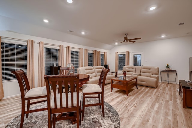 dining room with light hardwood / wood-style flooring, ceiling fan, and lofted ceiling