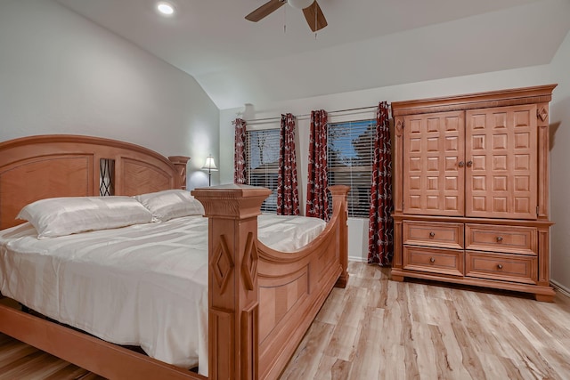 bedroom with light wood-type flooring, vaulted ceiling, and ceiling fan