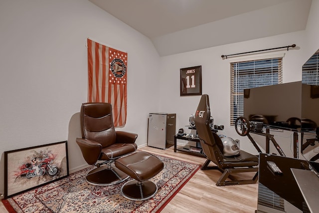 living area featuring hardwood / wood-style floors and lofted ceiling