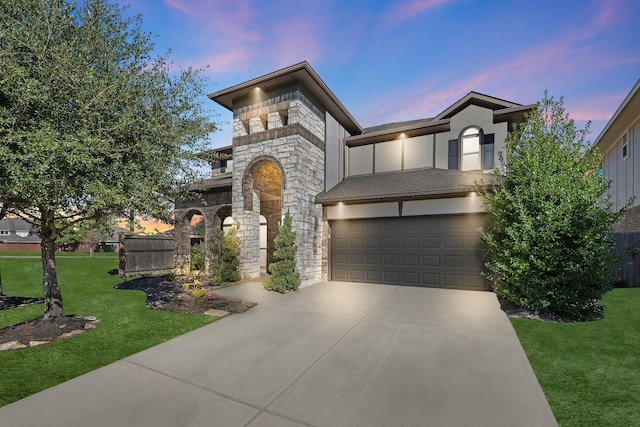 view of front of home with a garage and a yard