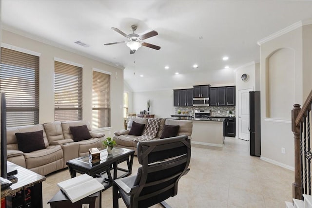 living room featuring light tile patterned floors, ceiling fan, and crown molding