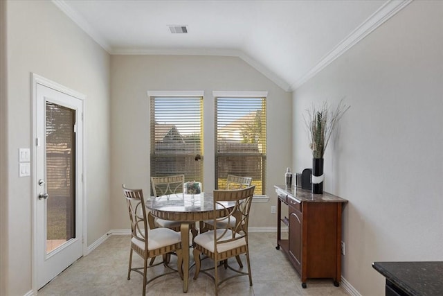 dining room with lofted ceiling and ornamental molding