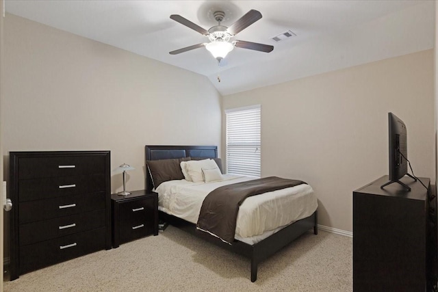 bedroom with ceiling fan, light colored carpet, and lofted ceiling