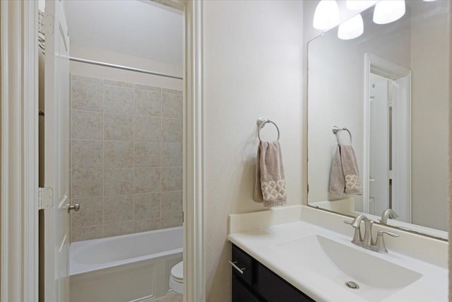 full bathroom with vanity, toilet, and tiled shower / bath