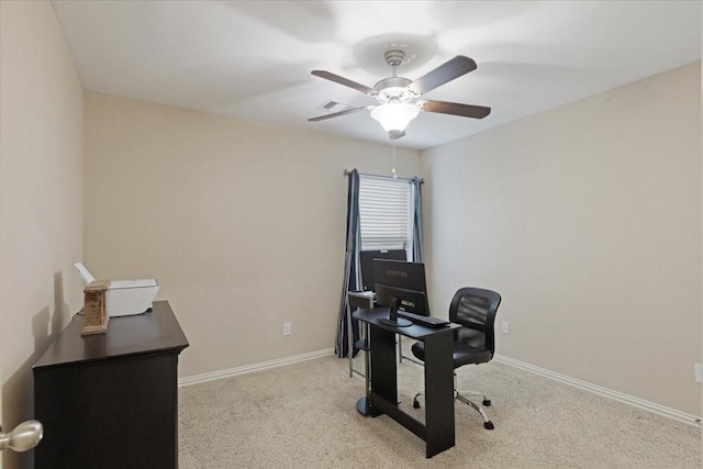 carpeted office space with ceiling fan