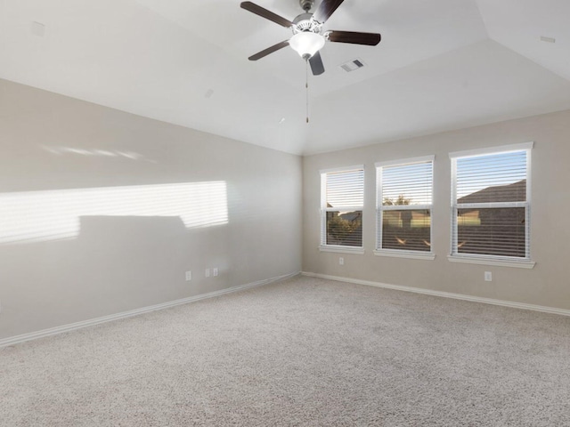 carpeted empty room featuring vaulted ceiling and ceiling fan