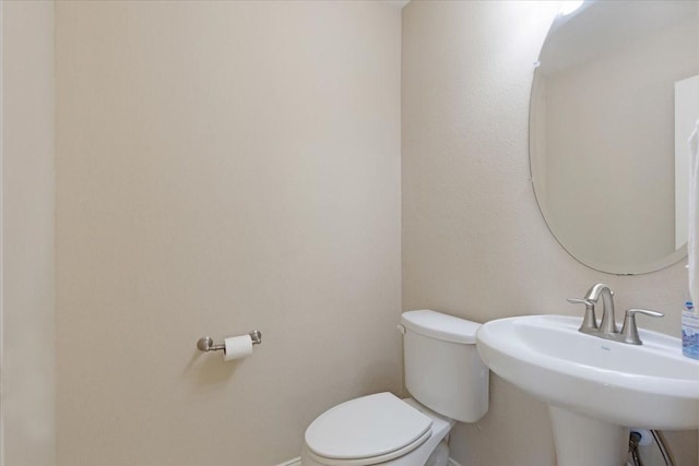 bathroom featuring toilet and sink