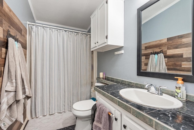 bathroom featuring toilet, vanity, a shower with shower curtain, and ornamental molding