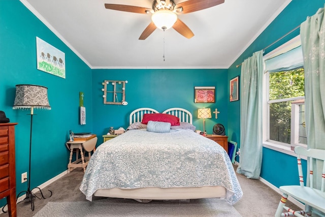 carpeted bedroom featuring ceiling fan and crown molding