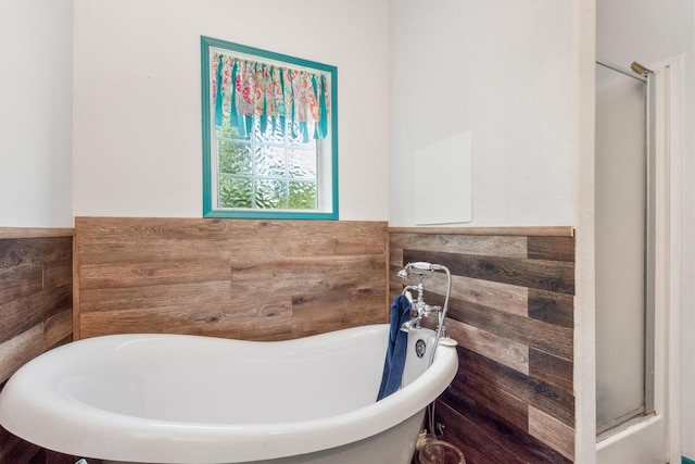 bathroom with tile walls and a bathing tub