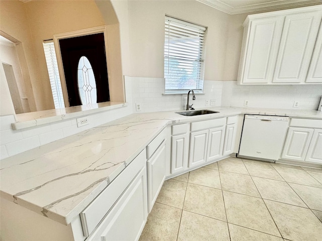 kitchen featuring light tile patterned floors, tasteful backsplash, dishwasher, white cabinetry, and a sink